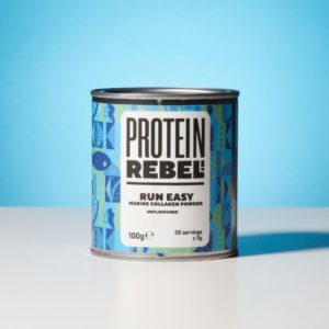 Metal tin of Protein Rebel Run Easy on a table top with blue background